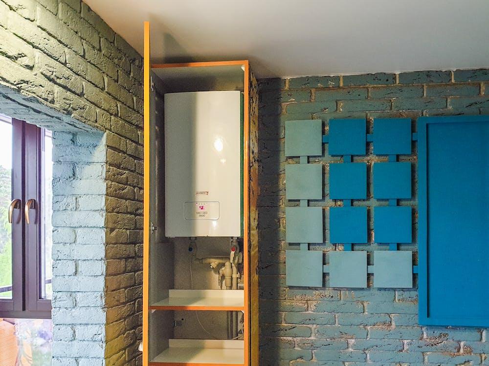 A tankless water heater in a bathroom cabinet