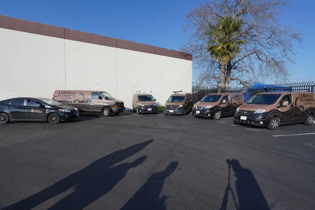 Lords of Plumbing fleet vans parked at the shop