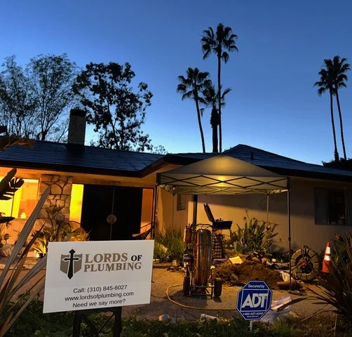 Lords of Plumbing yard sign outside a Los Angeles home at dusk