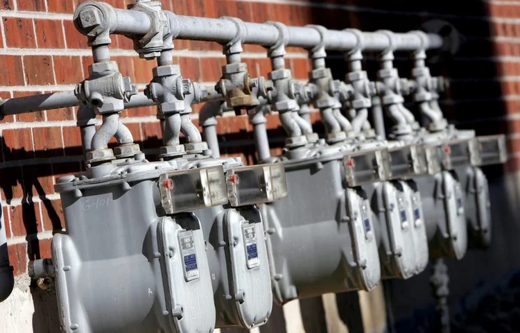 Bank of gas meters on the wall of a multi-unit building
