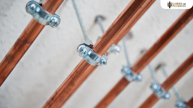 New copper water supply lines clamped to a wall during a whole-house repipe