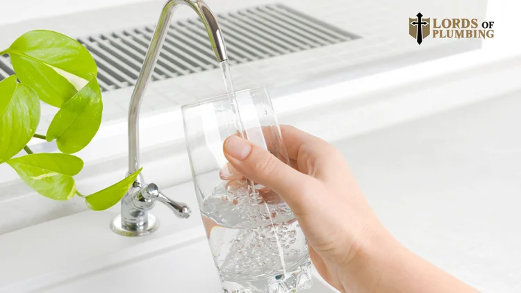 Filling a glass of water at a kitchen faucet